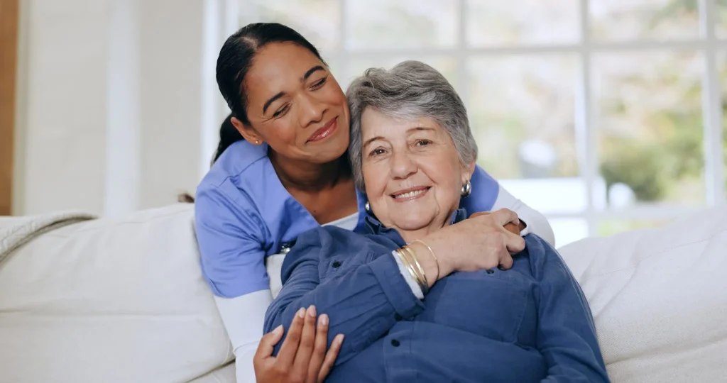 Caregiver supporting elderly woman